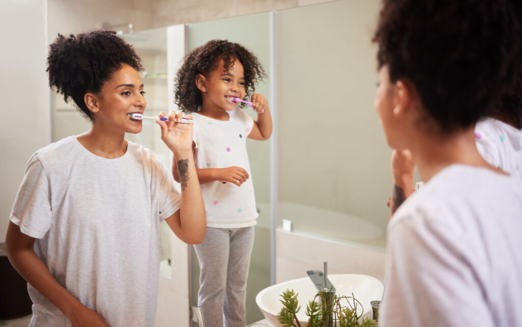 mirror reflection mom girl brushing teeth together while bonding having fun enjoy quality time child development learning dental care oral hygiene girl cleaning teeth bathroom mirror reflection mom girl brushing teeth together while bonding having fun enjoy quality time child development learning dental care oral hygiene girl cleaning teeth bathroom