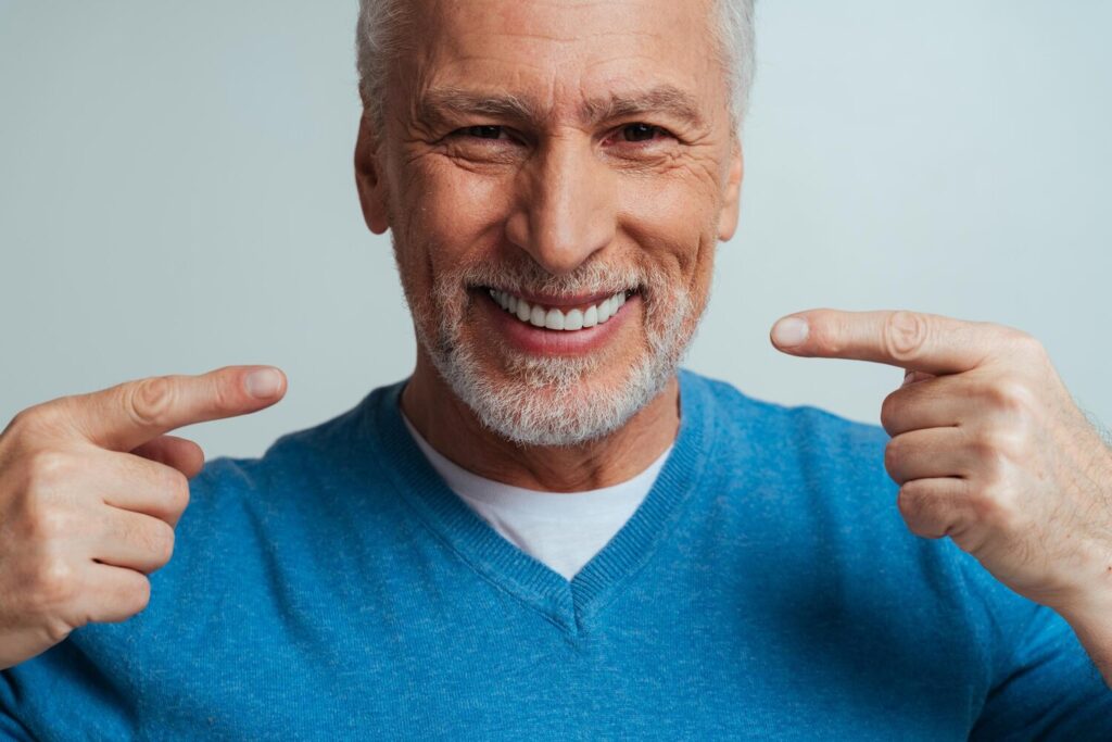 portrait smiling man wearing mask against gray background 1048944 30636159 portrait smiling man wearing mask against gray background 1048944 30636159