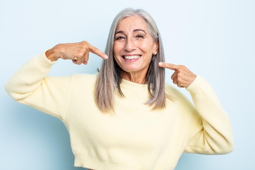 middle age gray hair woman smiling confidently pointing own broad smile positive relaxed satisfied attitude 1194 324641 middle age gray hair woman smiling confidently pointing own broad smile positive relaxed satisfied attitude 1194 324641