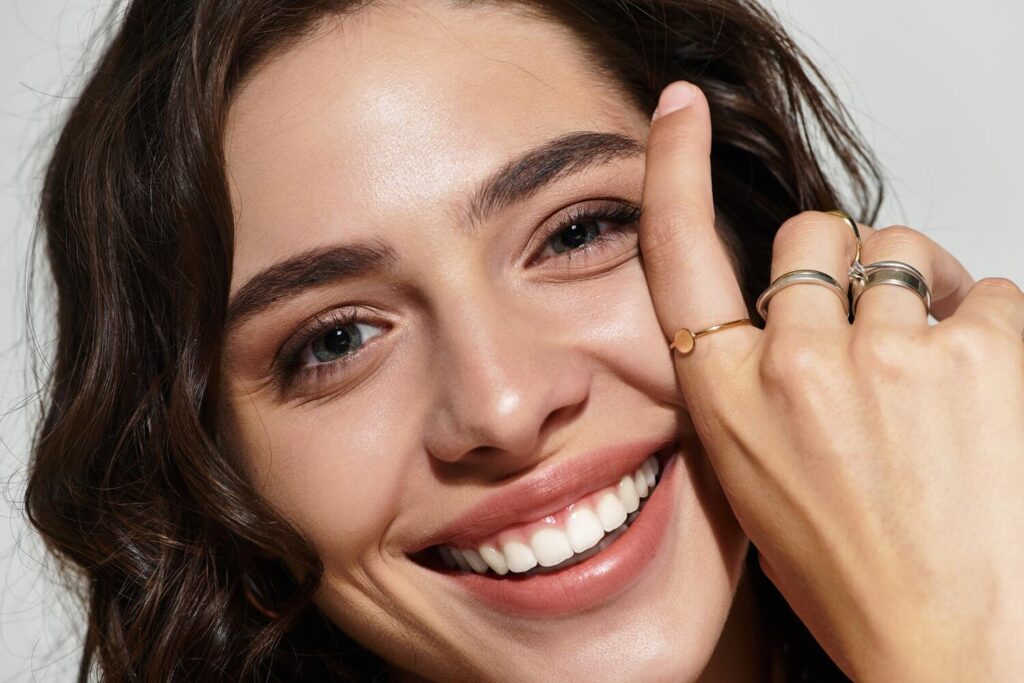 beautiful young woman showcasing elegant makeup jewelry modern studio setting 1326977 31191 beautiful young woman showcasing elegant makeup jewelry modern studio setting 1326977 31191
